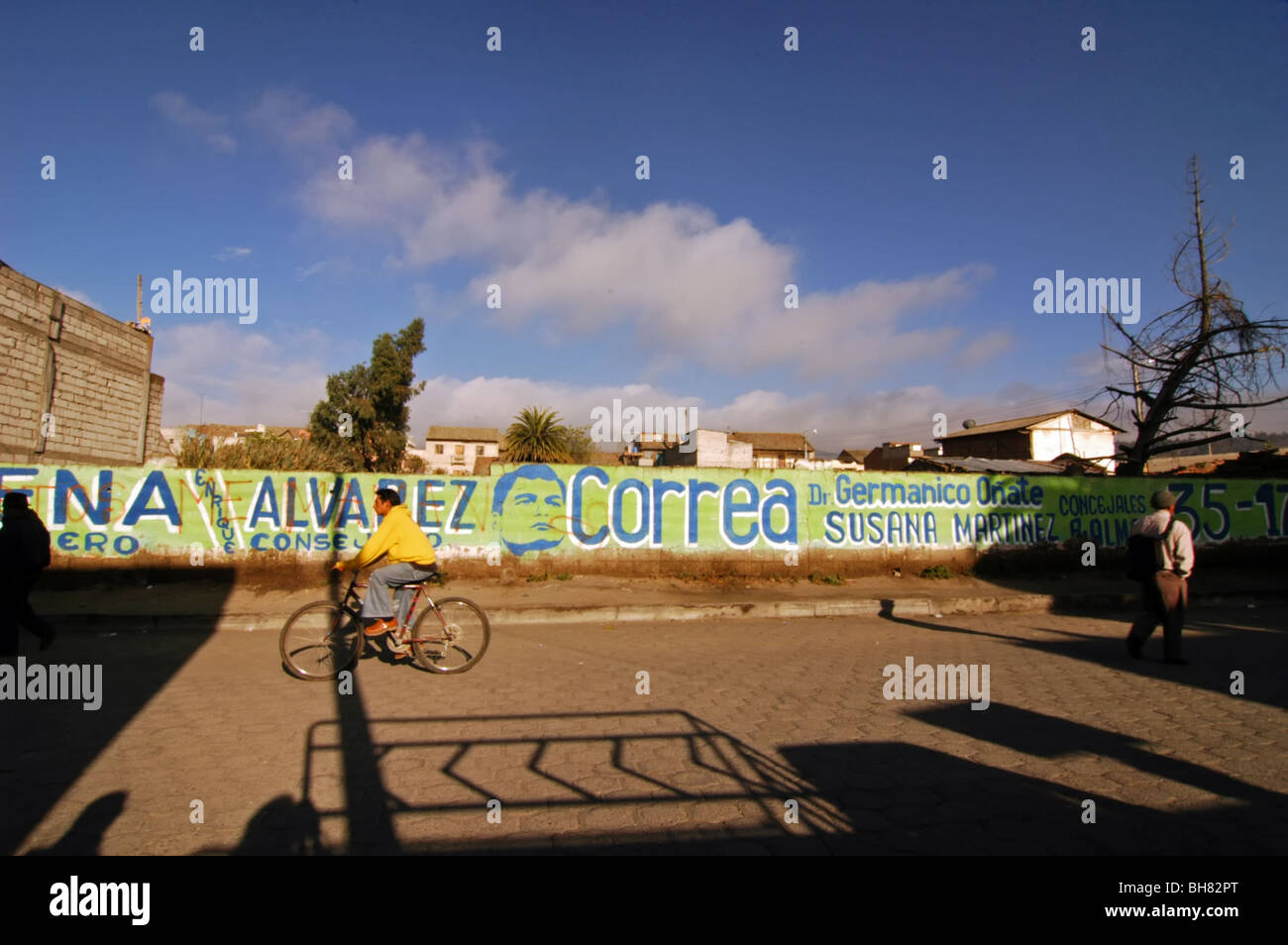 Ecuador, Saquisili, man on his bike cycling by a wall painted for the municipal elections campaign Stock Photo