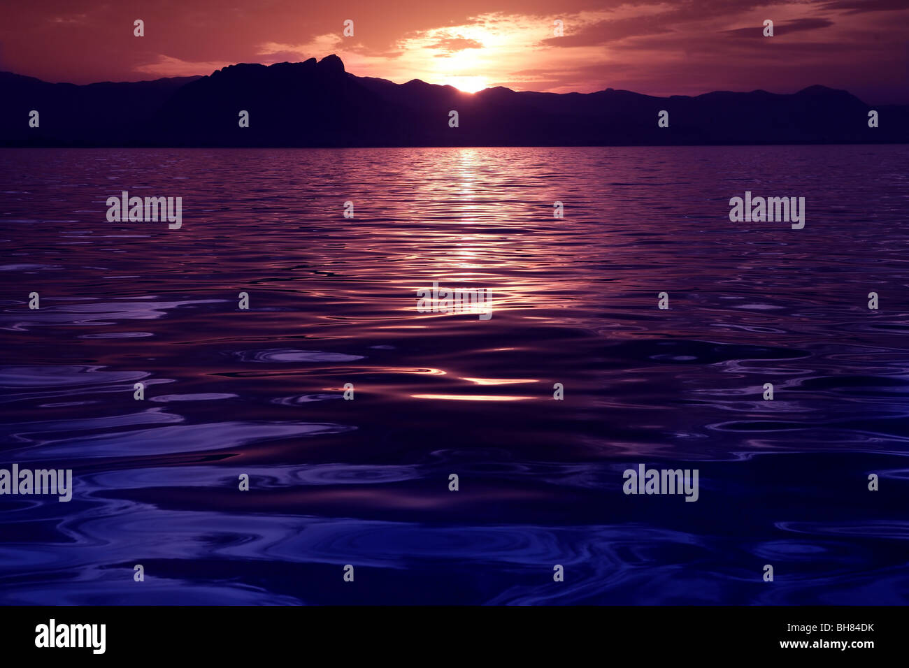 Beautiful seascape ocean sunset reflexion purple blue sea colors Stock Photo