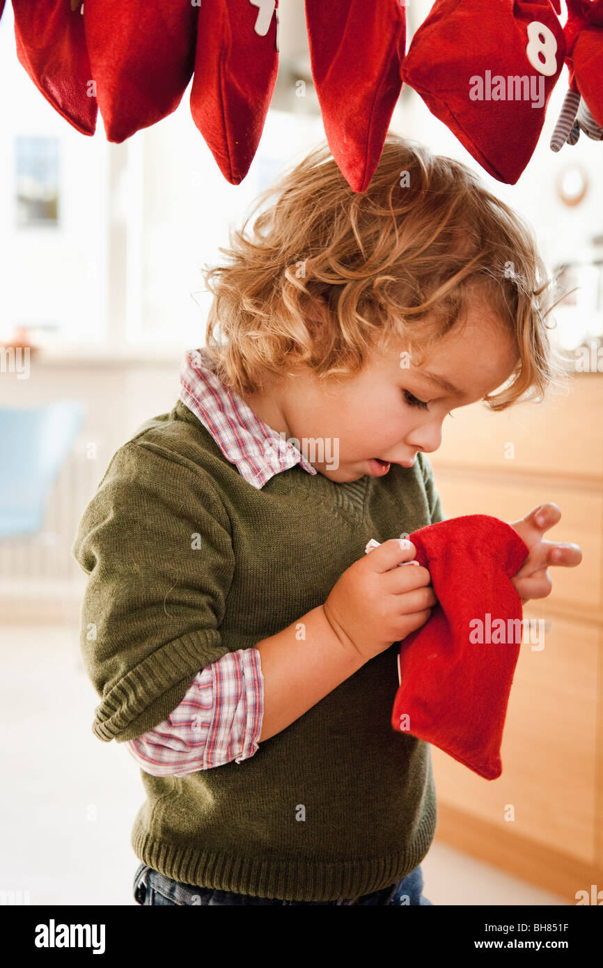 Young boy inspecting a christmas sack Stock Photo