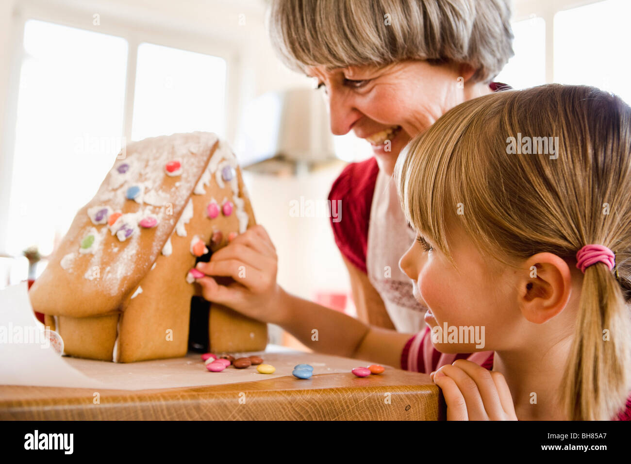 grandma and grandchild baking cake Stock Photo