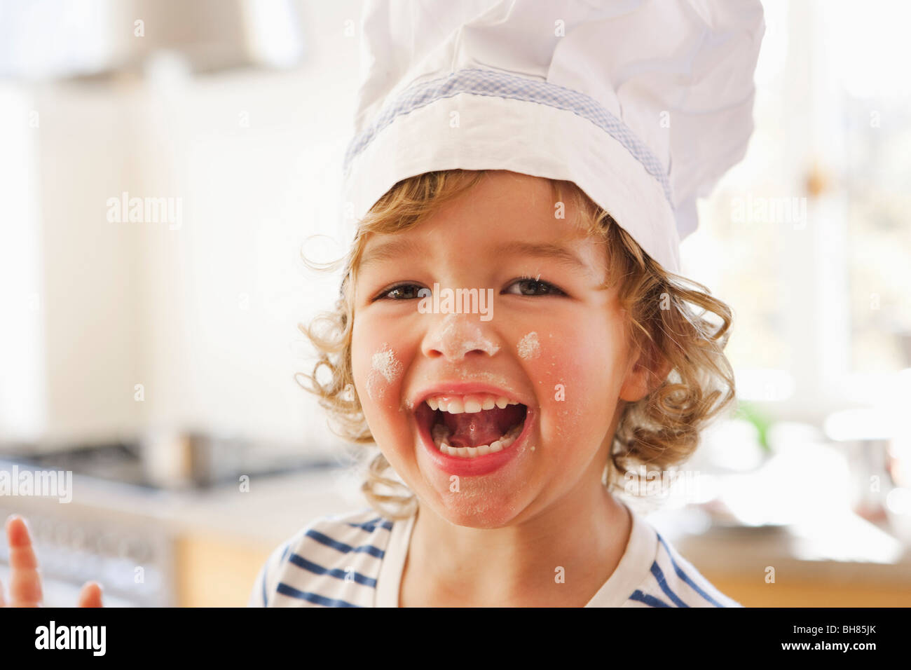 Young boy with flour in his face Stock Photo