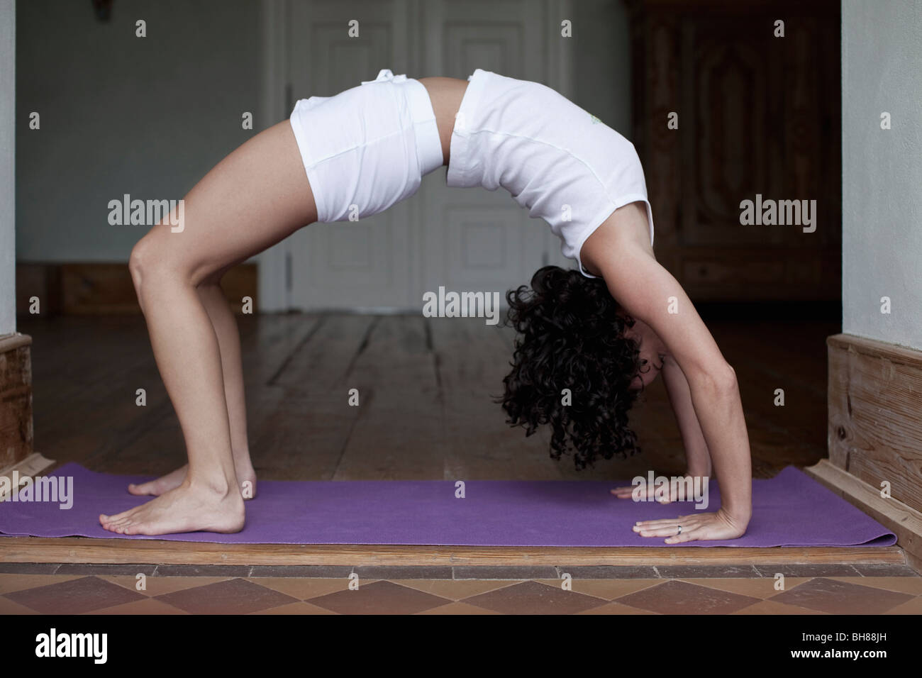 A woman doing the yoga bridge position Stock Photo