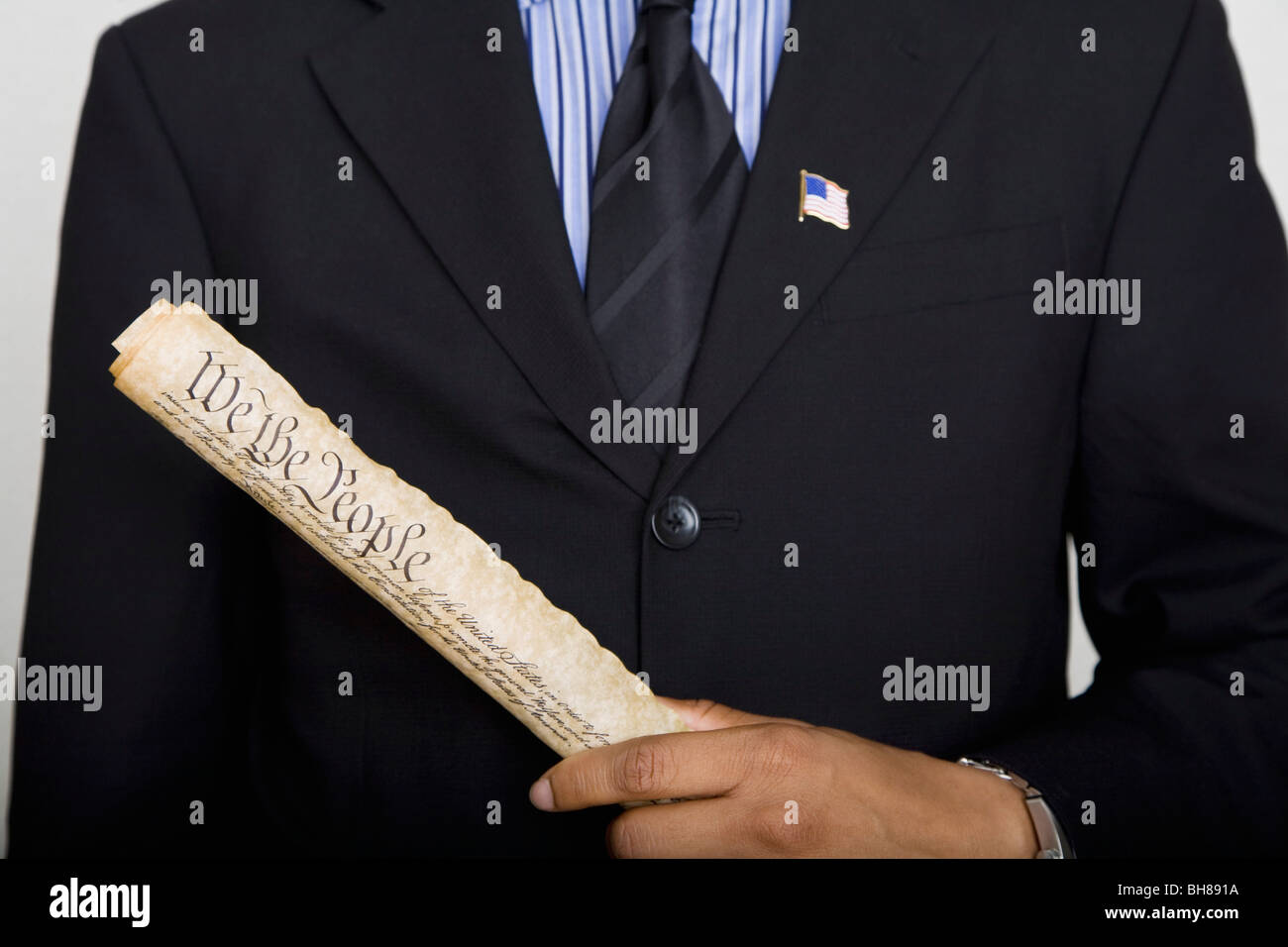 Midsection of a man holding a copy of the US Constitution Stock Photo