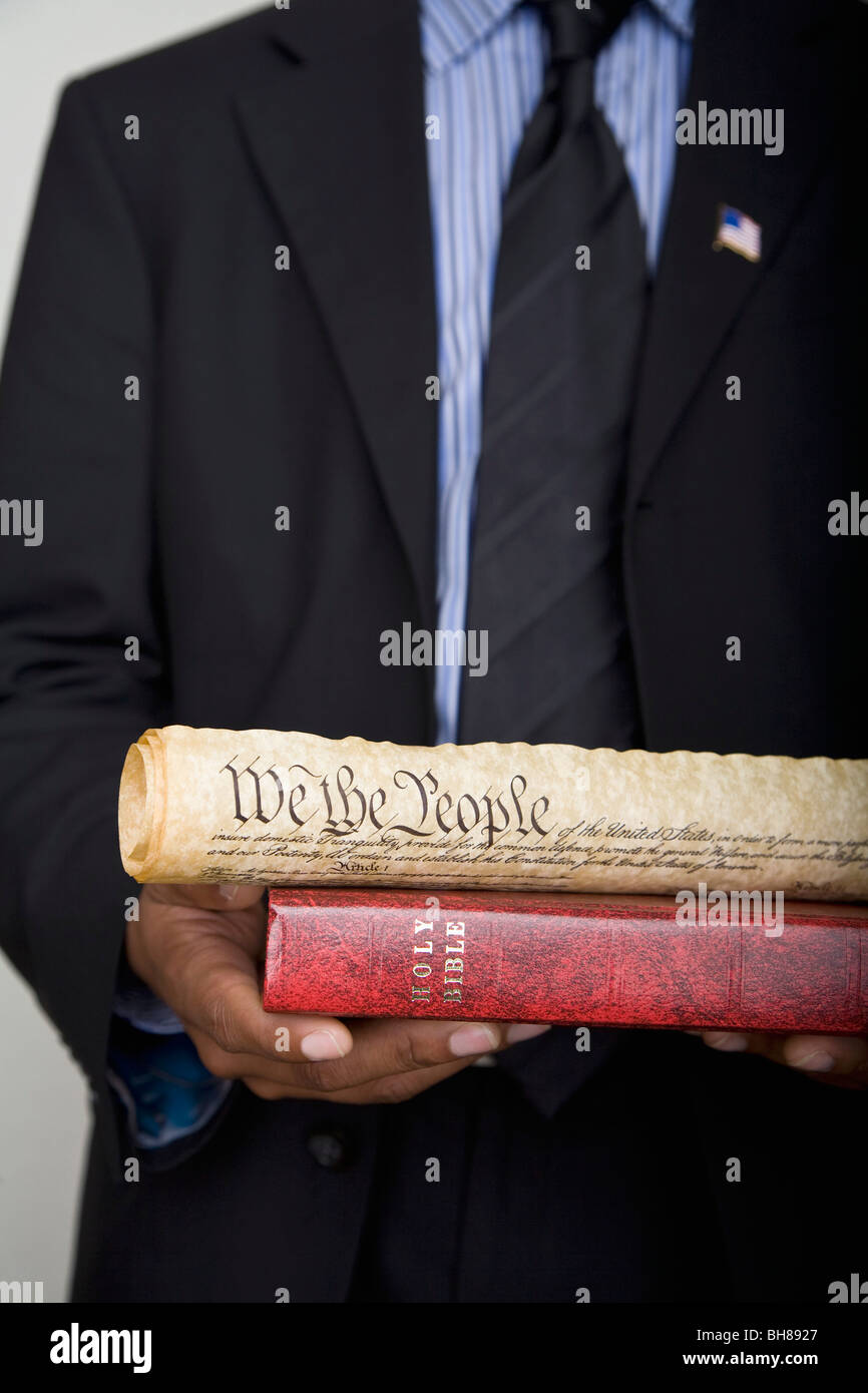 Detail of a man holding a Bible and a scroll of the American Constitution Stock Photo