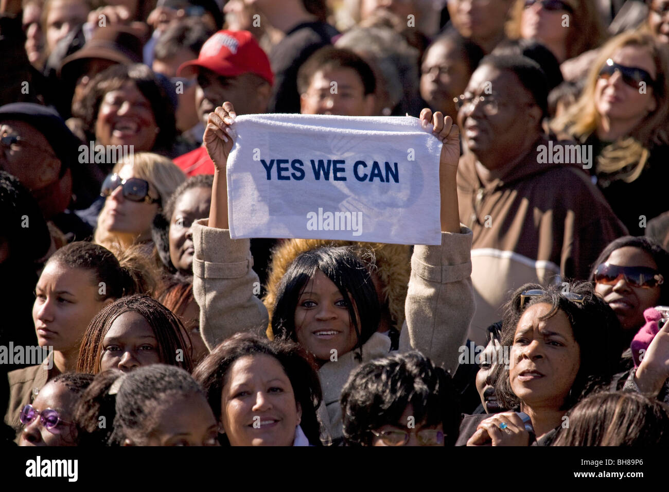 African American holding Yes We Can sign at early vote for change Presidential rally for US Senator Barack Obama Stock Photo