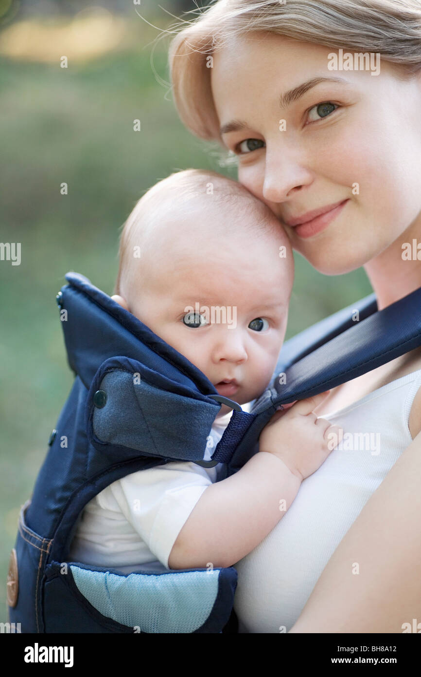 A mother with her baby in a baby carrier, portrait Stock Photo
