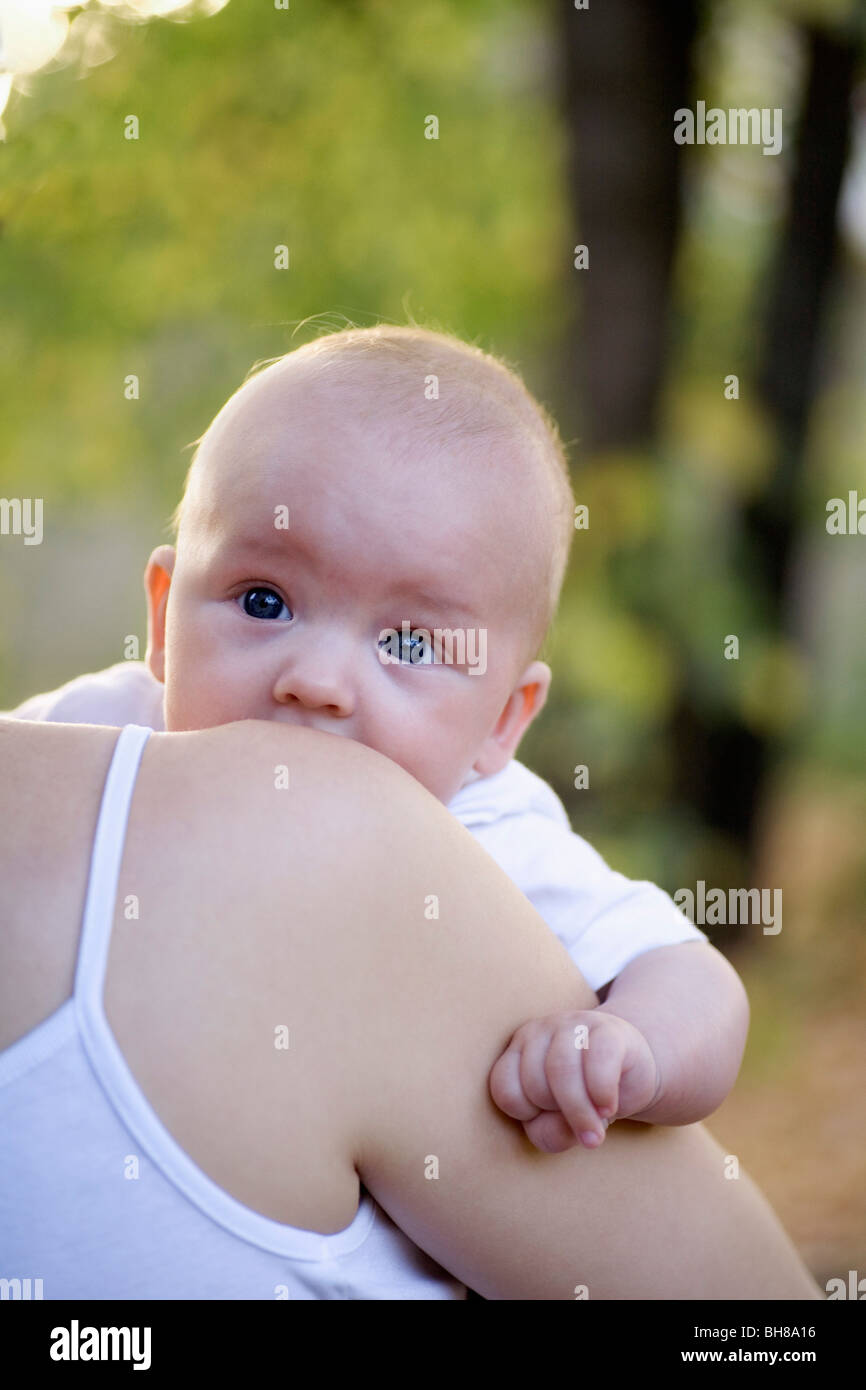 Close up of a mother carrying her baby boy hires stock photography and