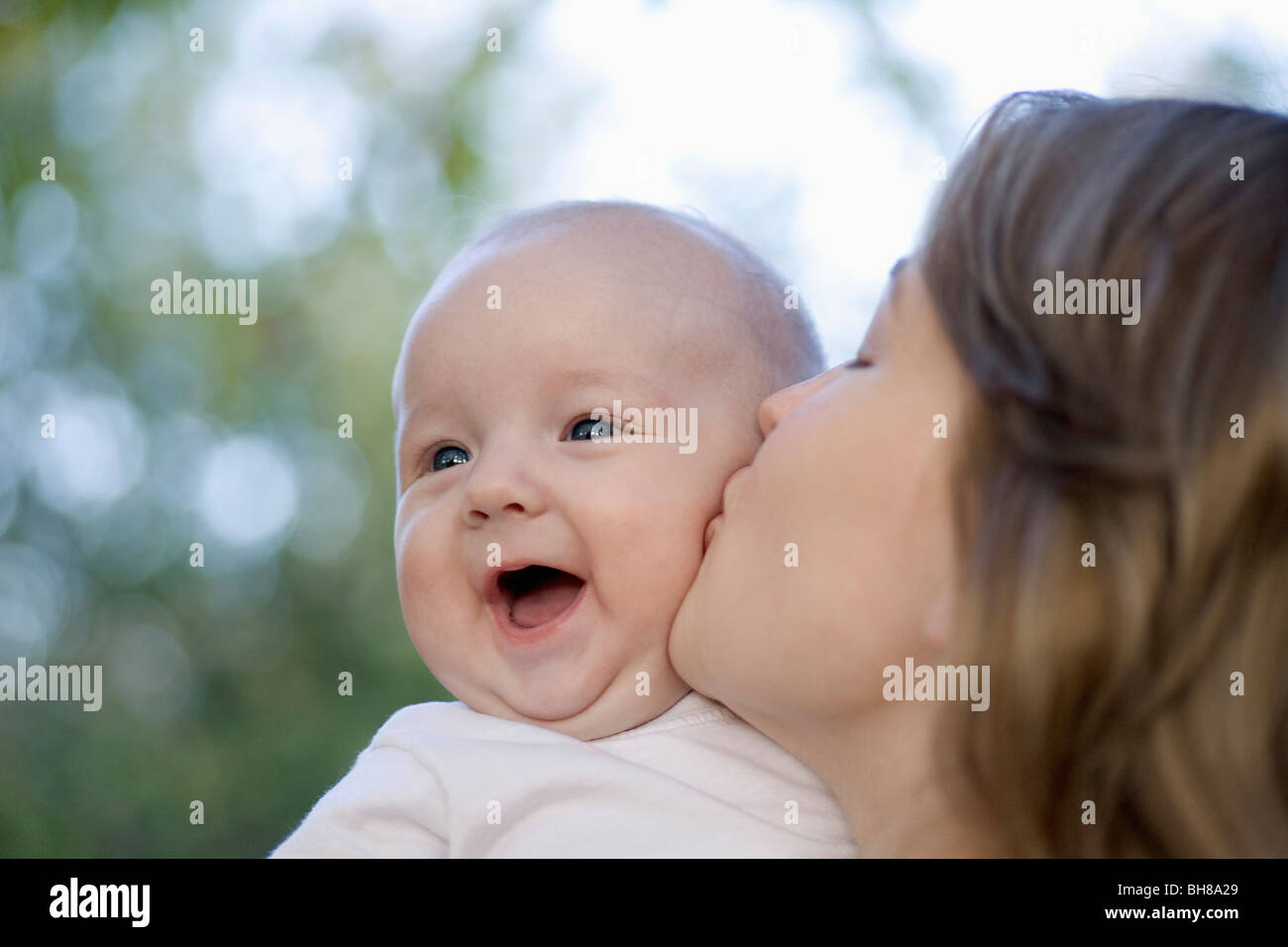 A mother kissing her baby boy Stock Photo