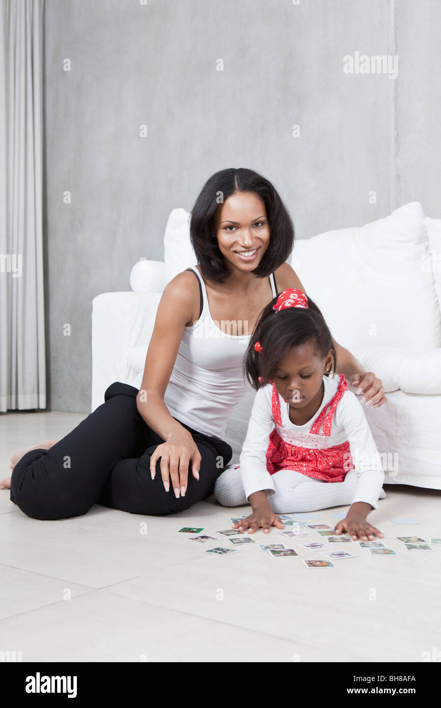 A young mother and her daughter playing a card game Stock Photo