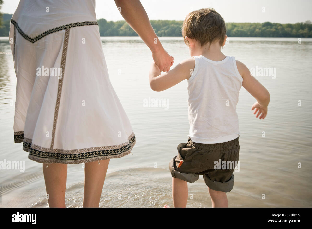 Mother holding child's hand Stock Photo
