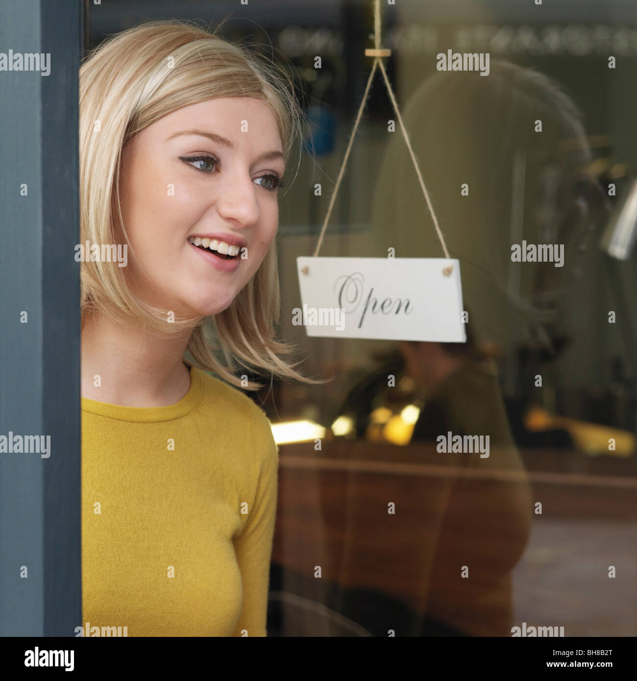woman at glass door Stock Photo