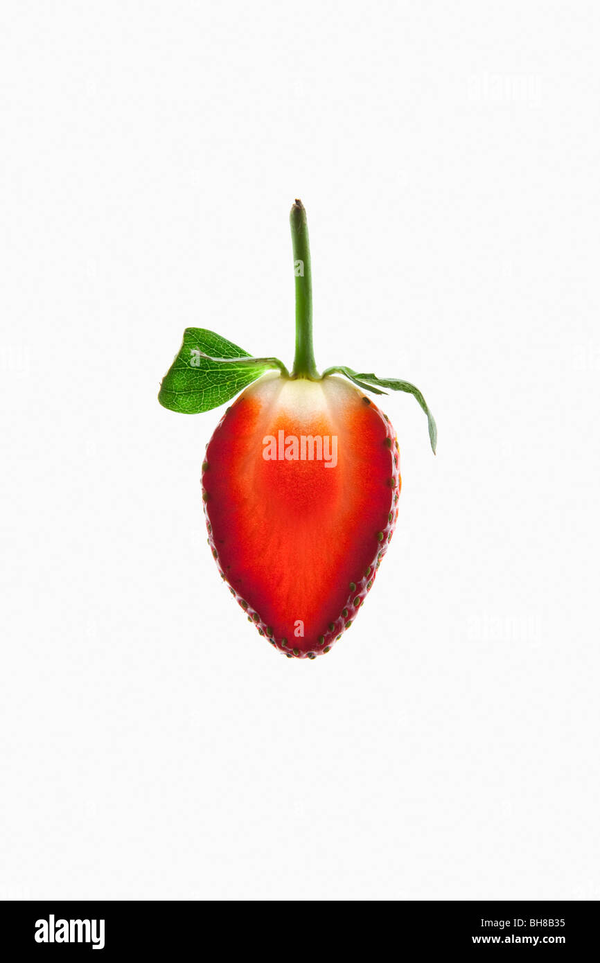 A slice of an organic strawberry on a lightbox Stock Photo