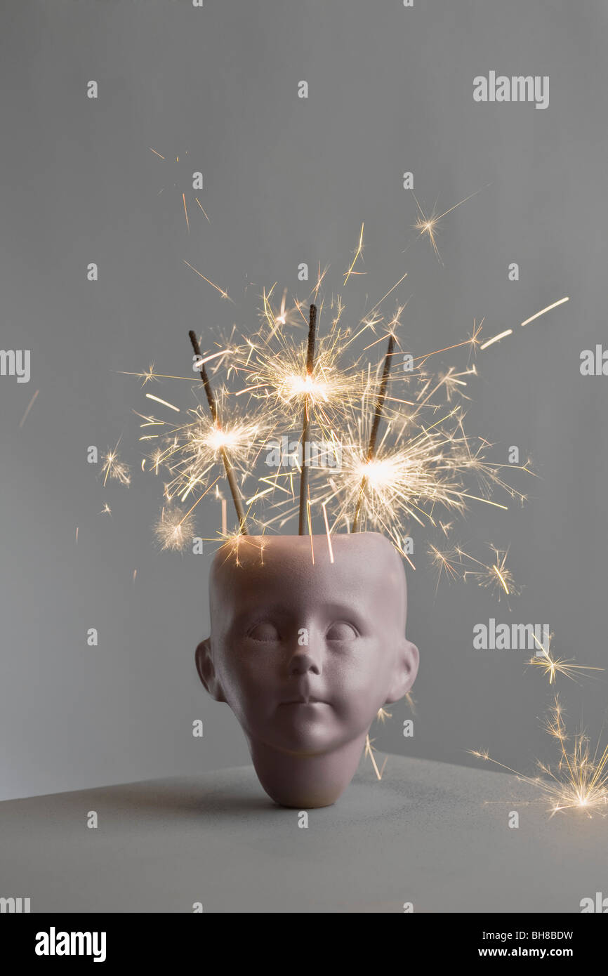 Lit sparklers in a porcelain head Stock Photo