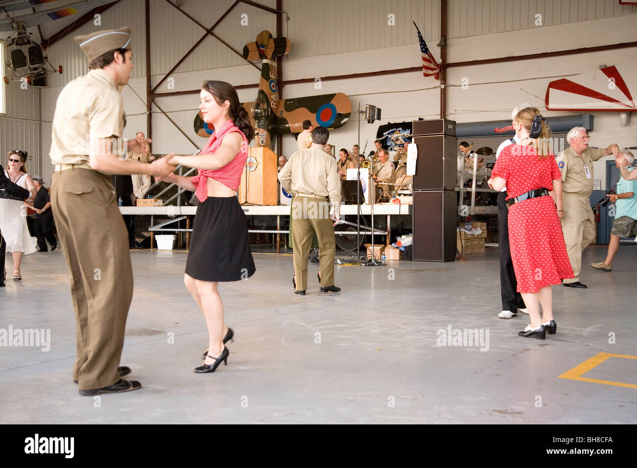 World War II actors dance in airport hanger at Mid-Atlantic Air Museum World War II Weekend and Reenactment in Reading, PA Stock Photo