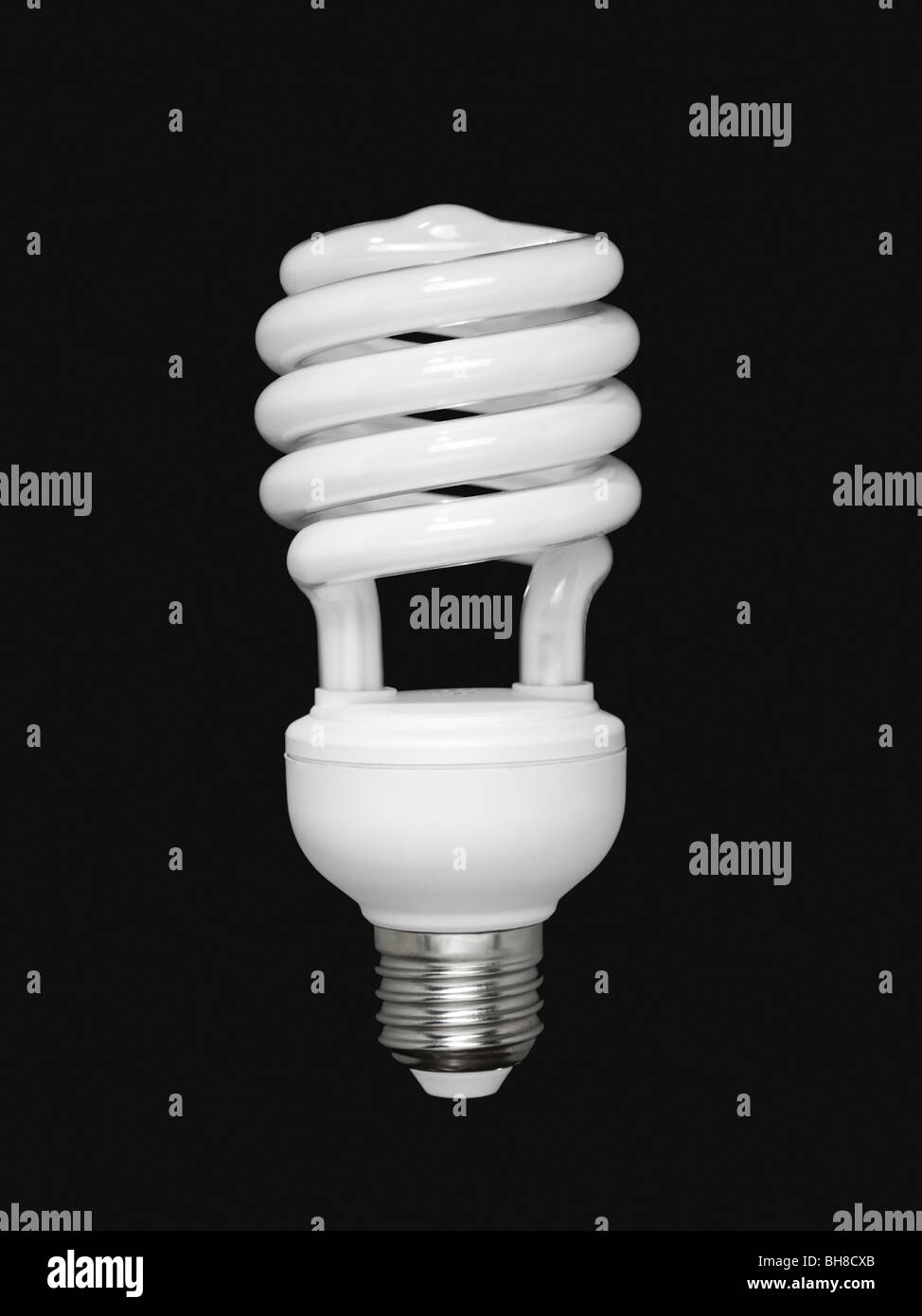 Compact fluorescent light bulb isolated over black background Stock