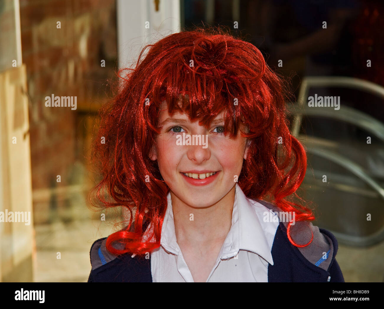 Young boy wearing a fancy dress wig Stock Photo Alamy