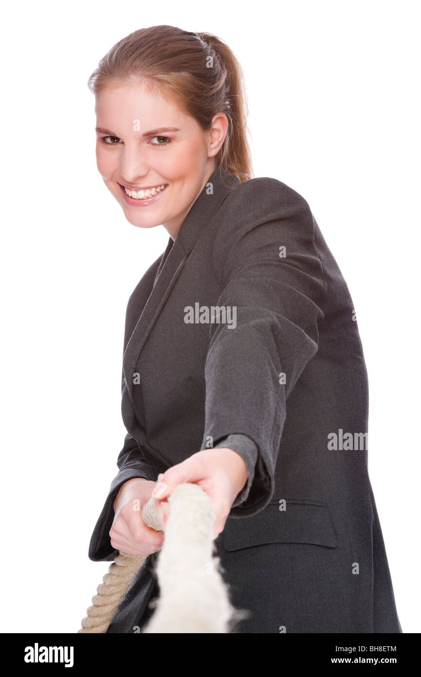 Full isolated studio picture from a young and beautiful business woman doing tug of war Stock Photo