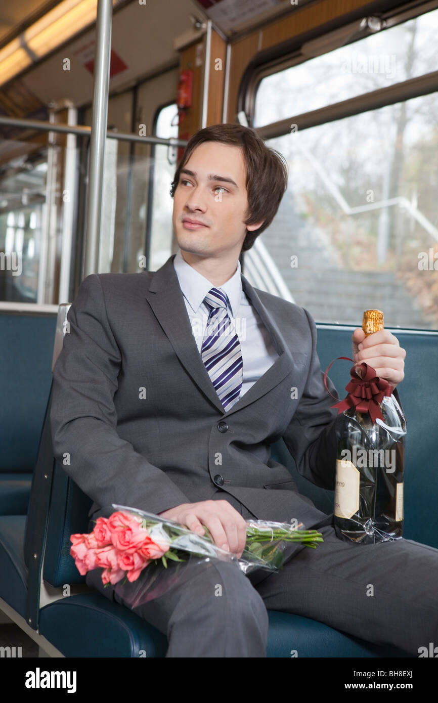 businessman in tube, champagne, flowers Stock Photo