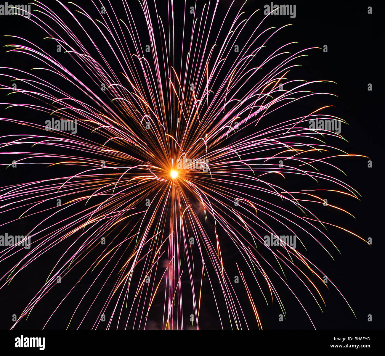 A colorful fireworks display going off in the night Stock Photo