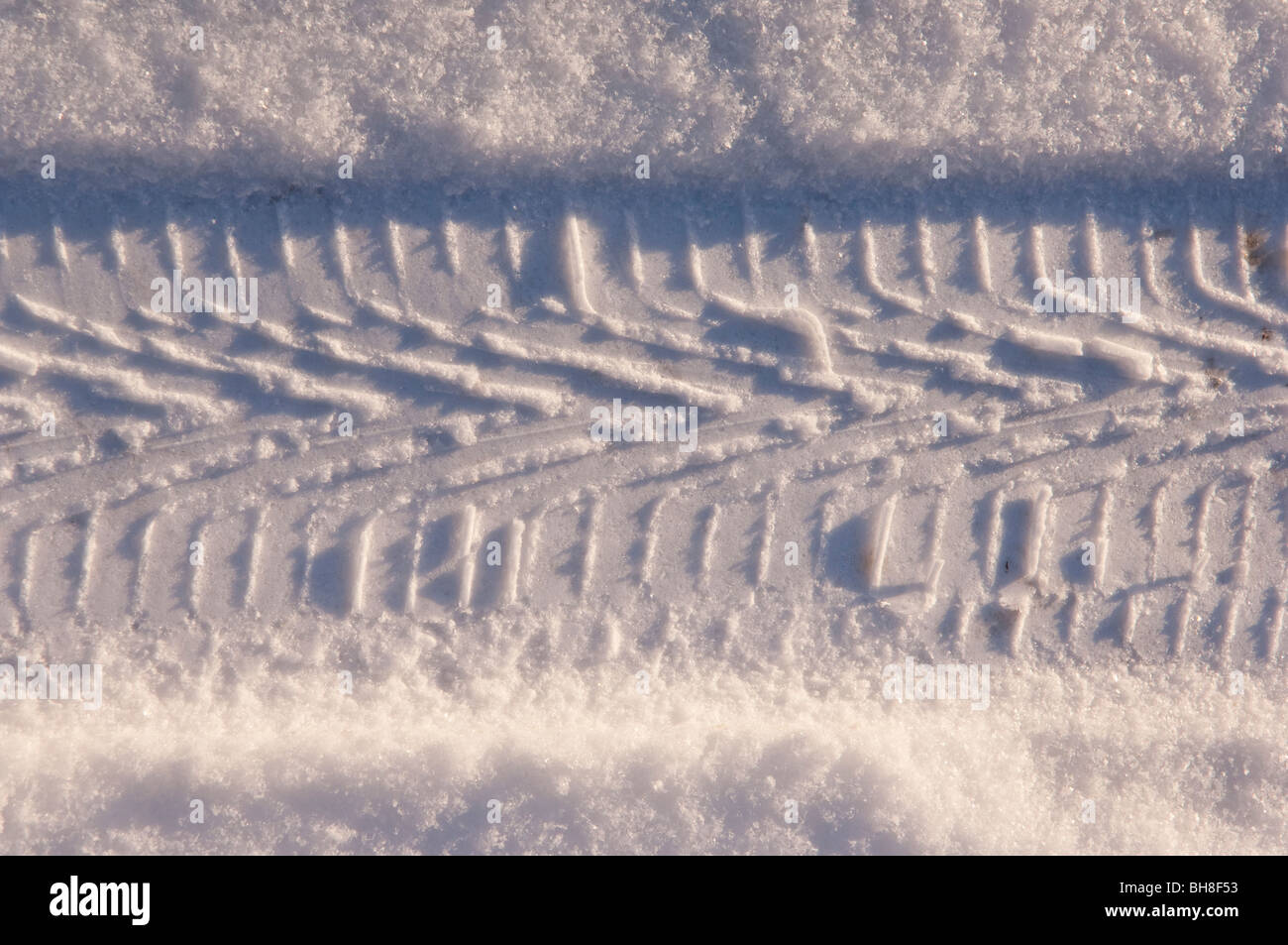 A tyre track in the snow Stock Photo - Alamy