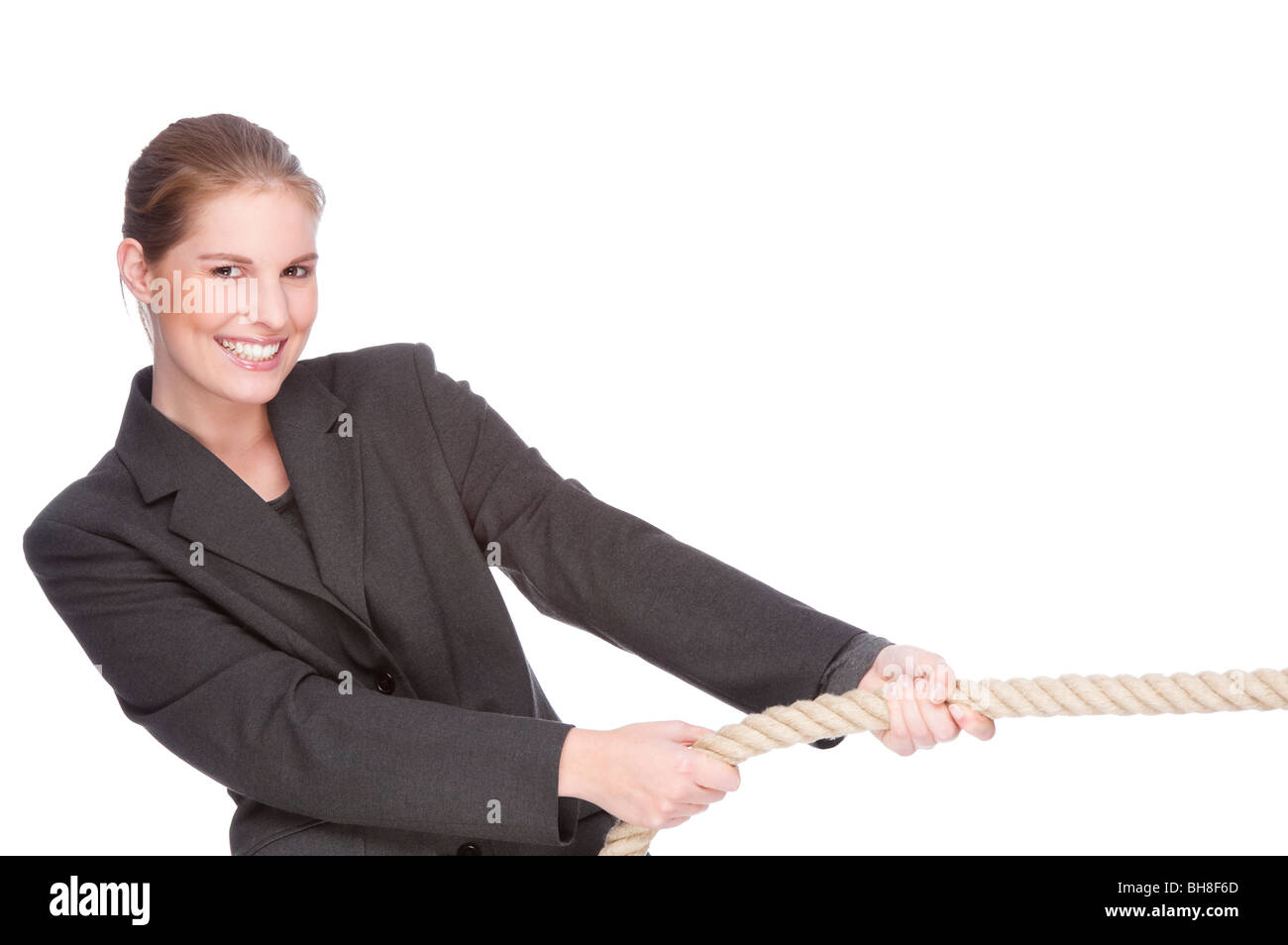 Full isolated studio picture from a young and beautiful business woman doing tug of war Stock Photo