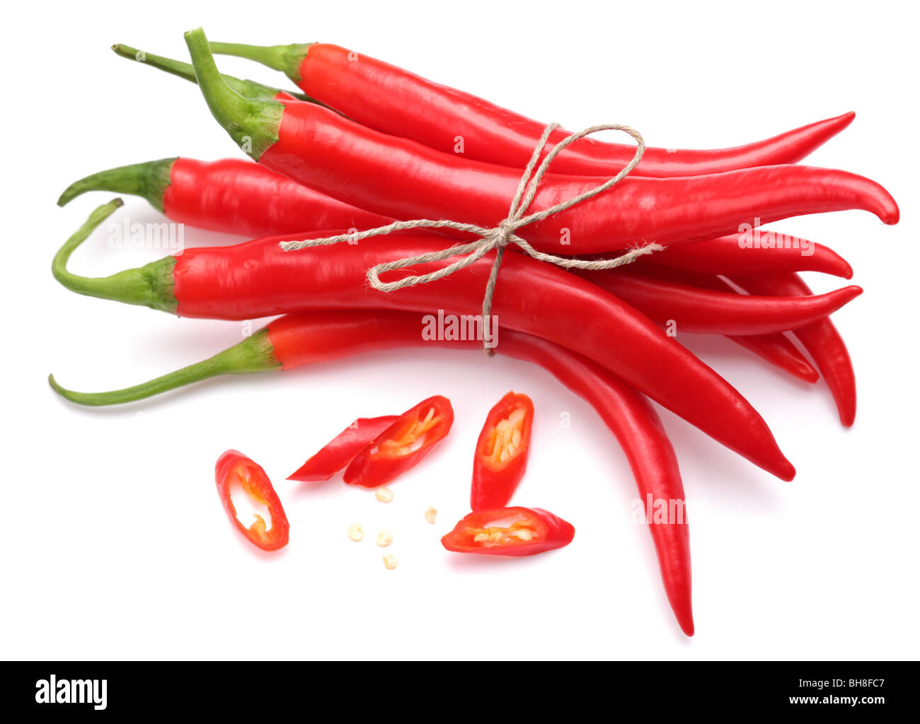 Chilean red pepper slices and seeds on a white background Stock Photo