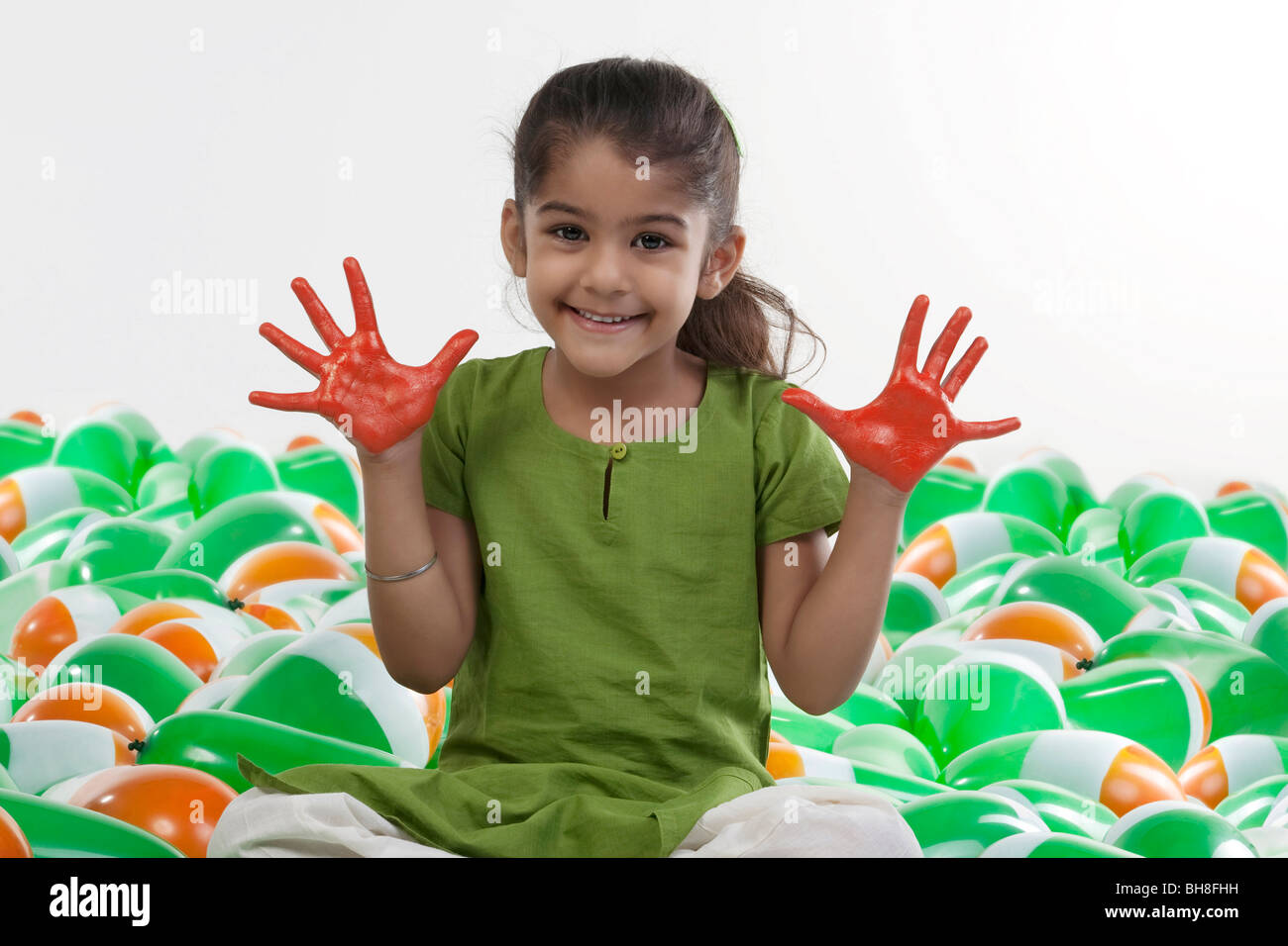 Girl with hands painted red Stock Photo