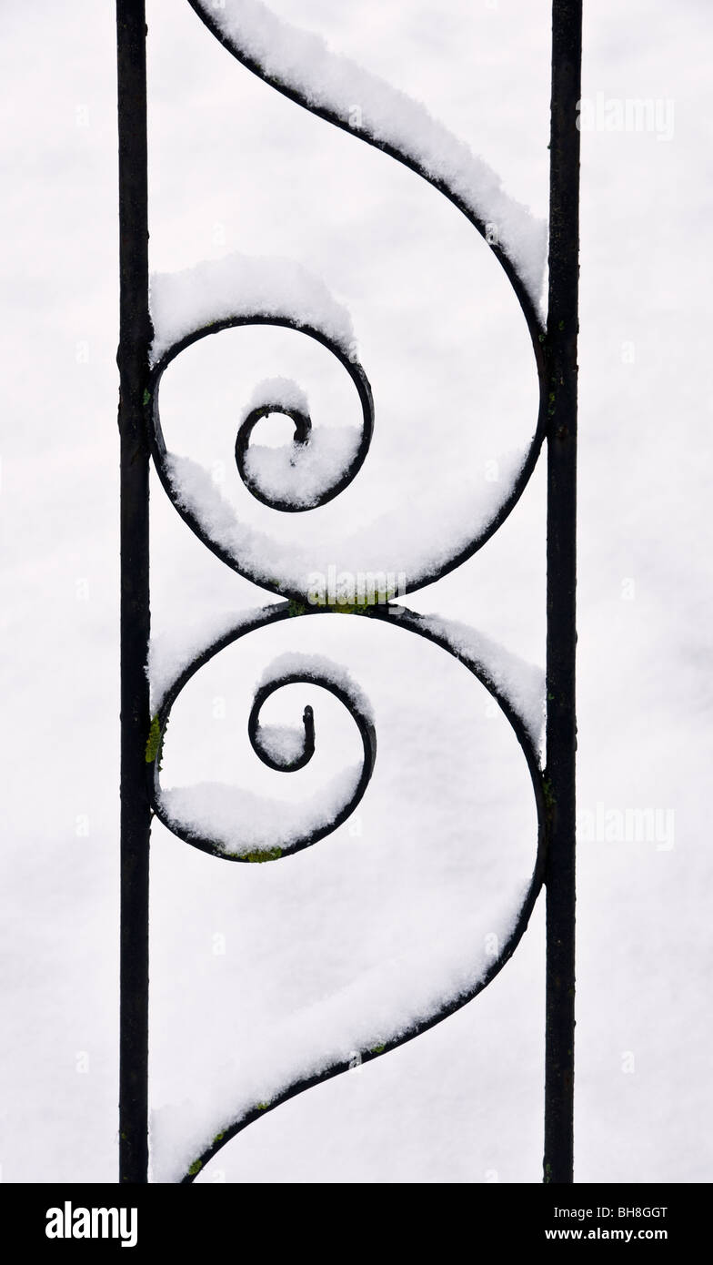 snow on decorative wrought iron gate Stock Photo