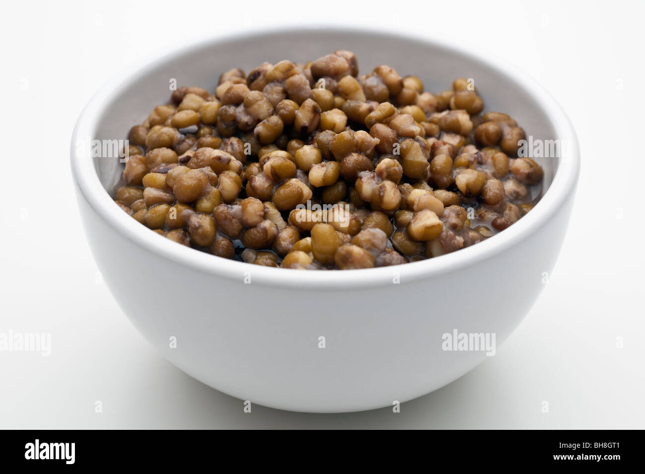 Dish full of cooked Mung beans in water Stock Photo