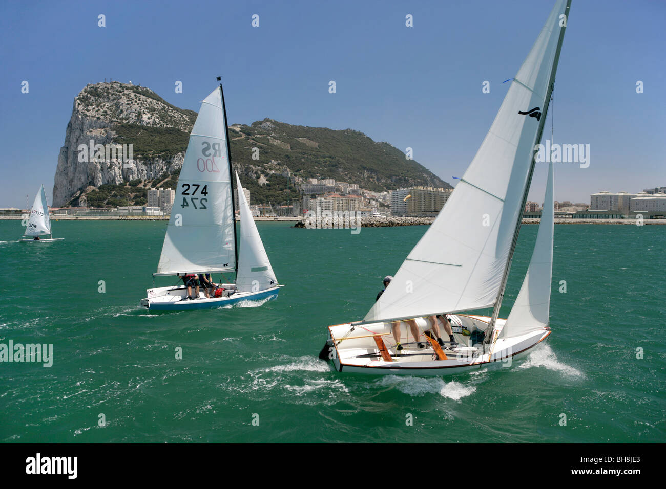 A dinghy sailboat race taking place in the bay below Gibraltar, England
