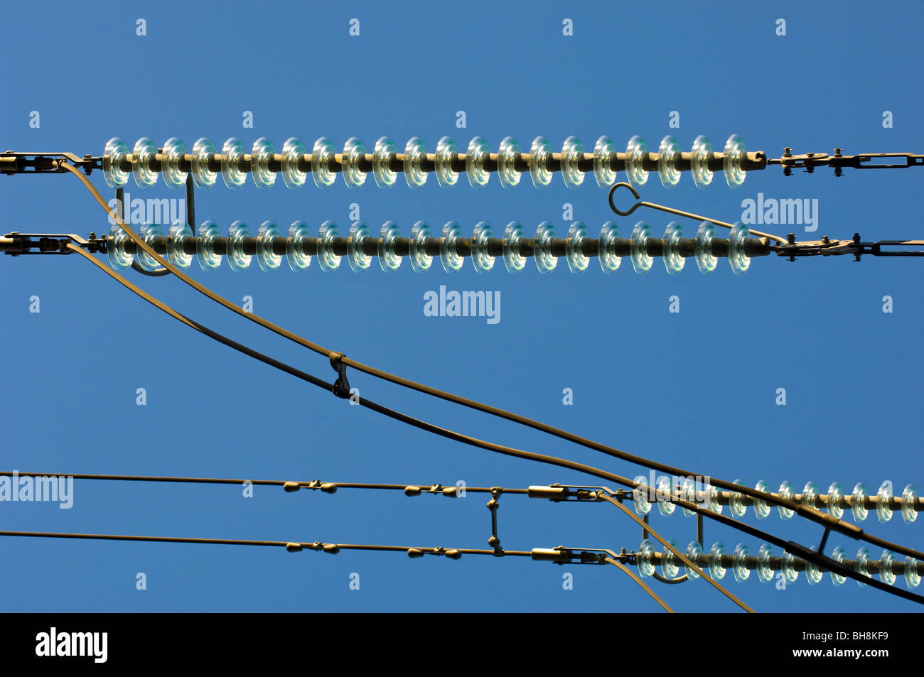 High voltage overhead cables transmission lines operating at 275kV with glass insulators. Stock Photo