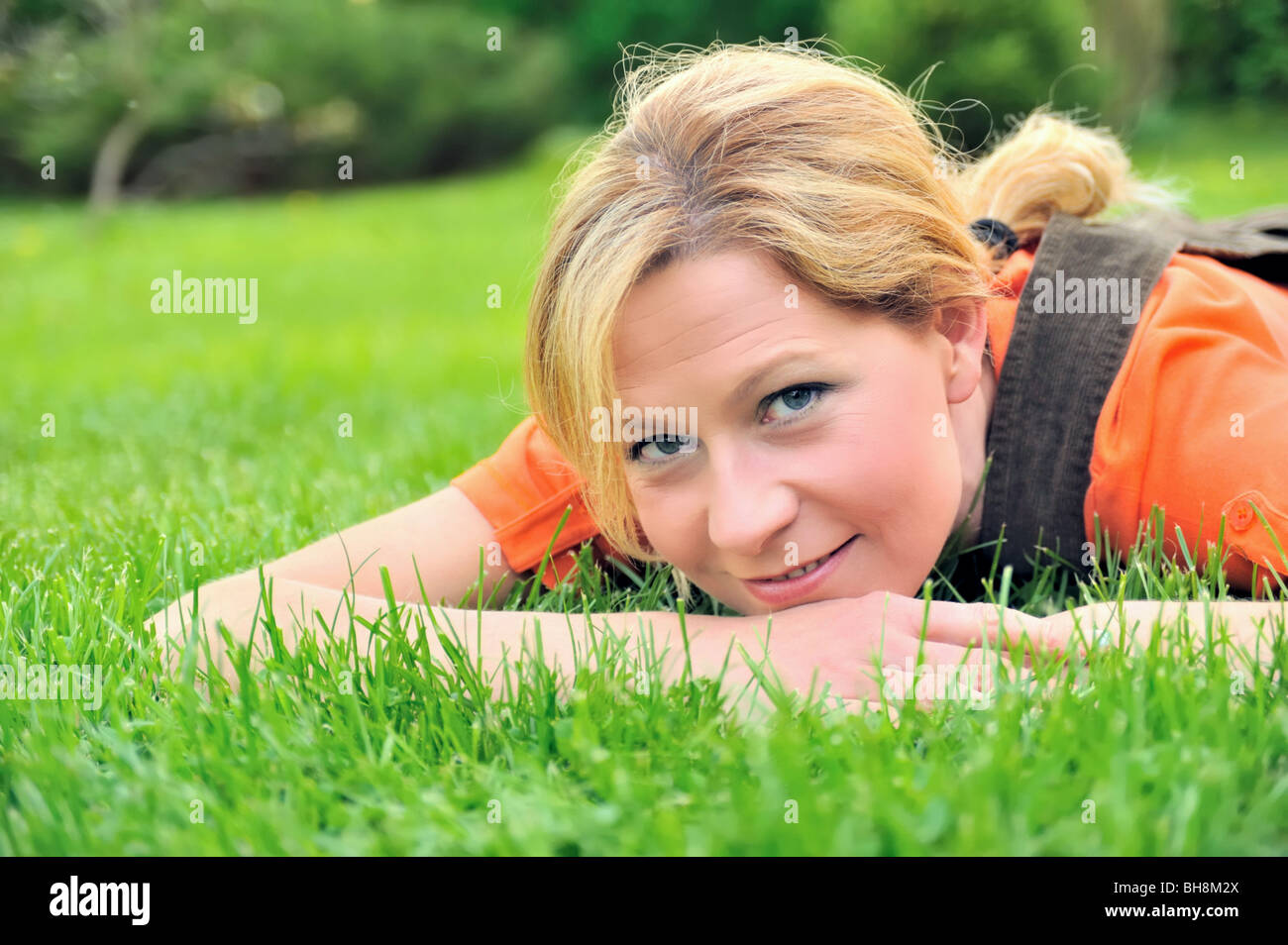 Young woman relaxing on the grass Stock Photo - Alamy