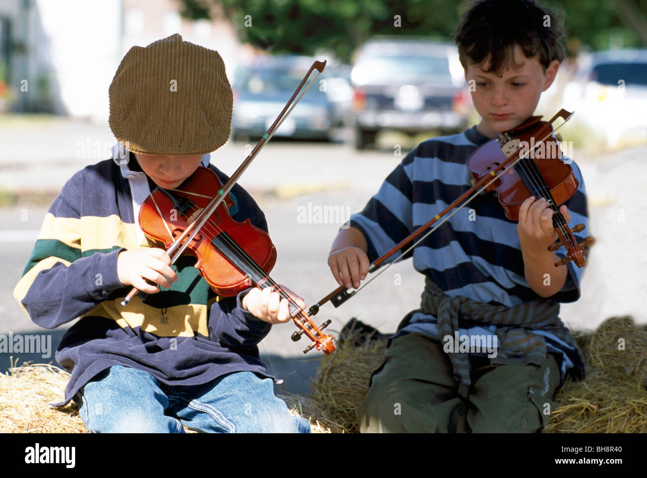 Young Boys playing Violin Fiddle Music, Children Fiddler Musicians Players at Farm Fair, Port Townsend, Washington State, USA Stock Photo