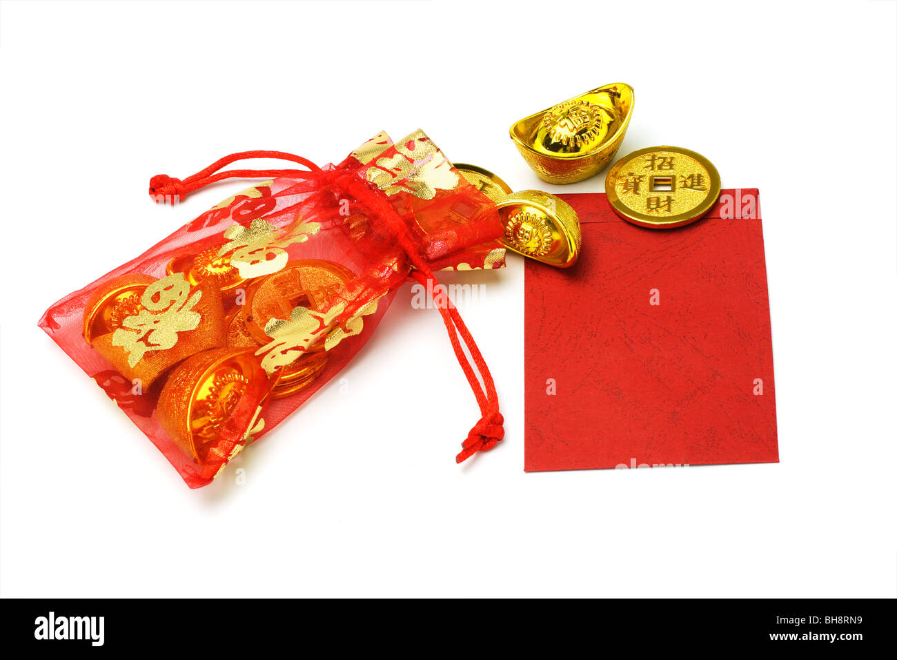 Chinese new year gold ingots and coins in red sachet and red packet on white background Stock Photo