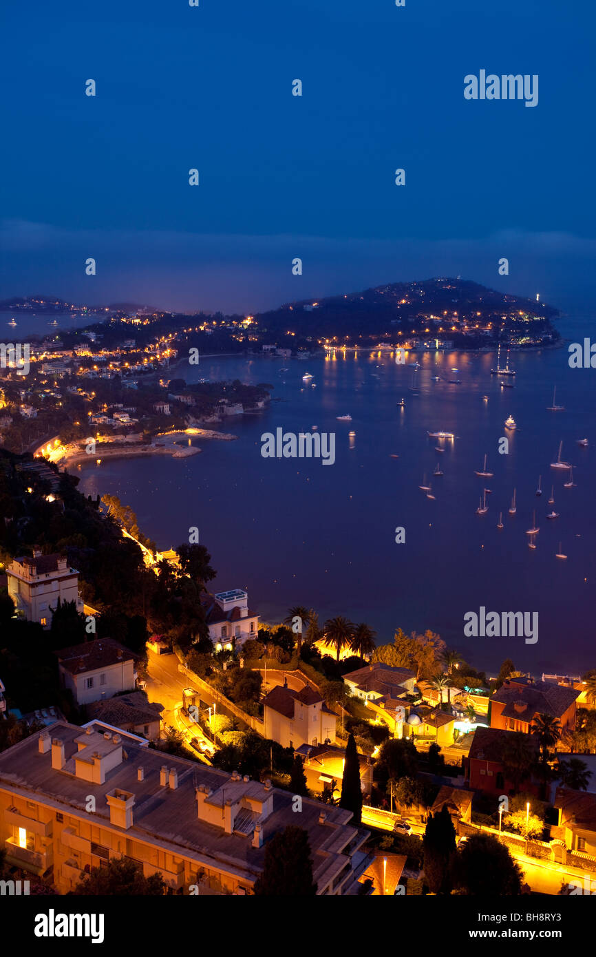 Dusk view of Villefranche-sur-mer with the peninsula of Saint-Jean and Cap-Ferrat beyond, Provence France Stock Photo