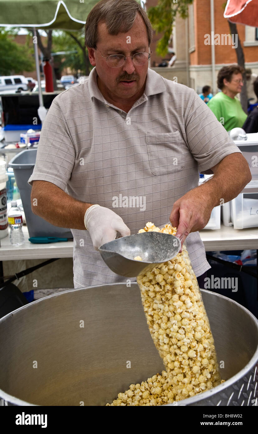 Man serving up a large bag of candy corn, Missoula, Montana, USA Stock Photo