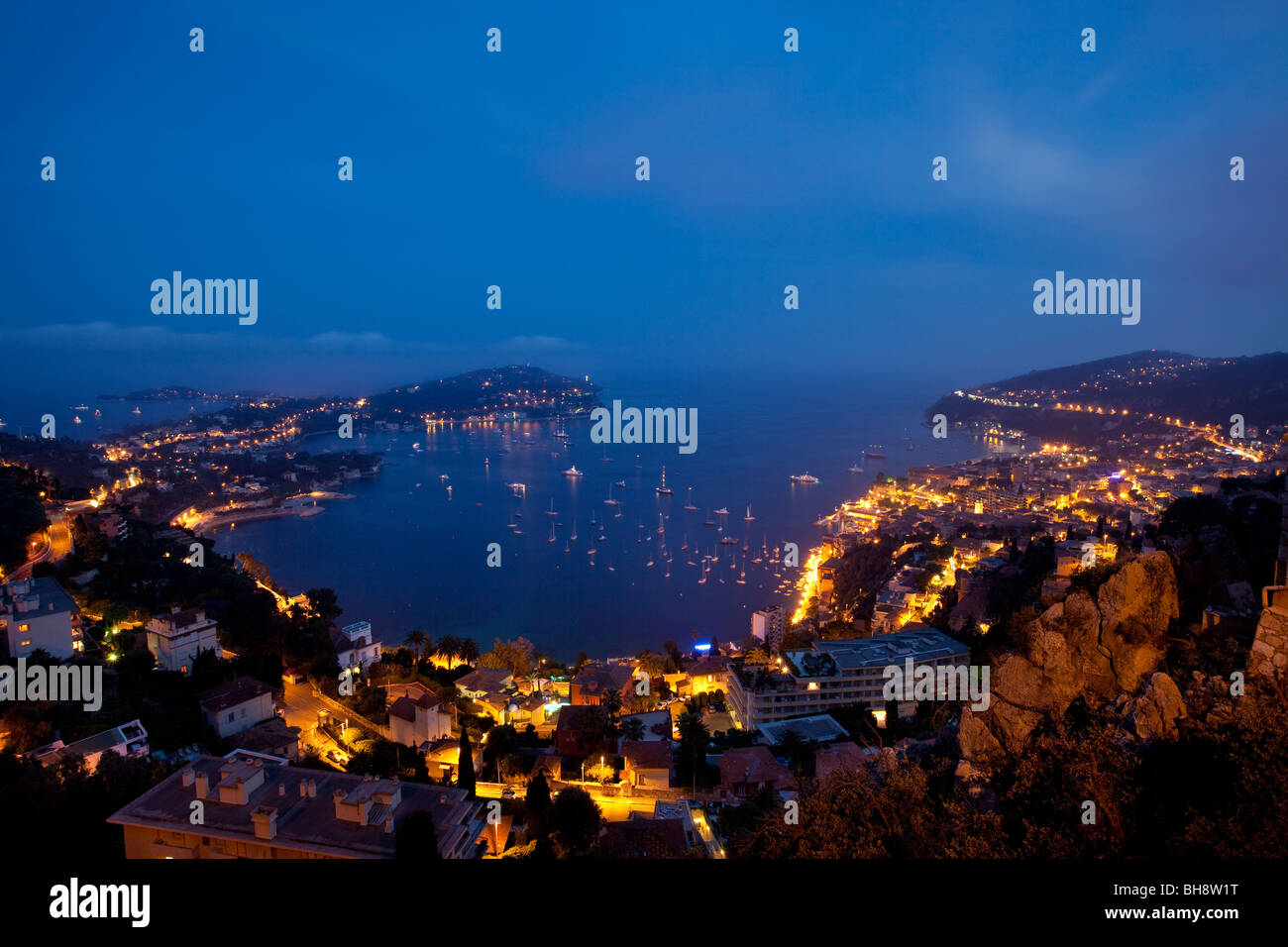 Dusk view of Villefranche-sur-mer with the peninsula of Saint-Jean and Cap-Ferrat beyond, Provence France Stock Photo