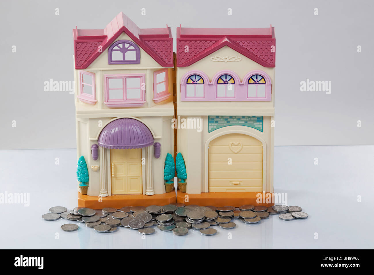Toy house and coins Stock Photo Alamy