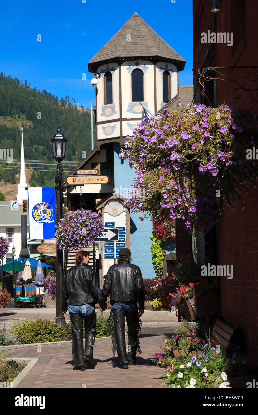 Leather clad male and female bikers walking hand in hand towards Park Street Leavenworth, Washington, USA Stock Photo