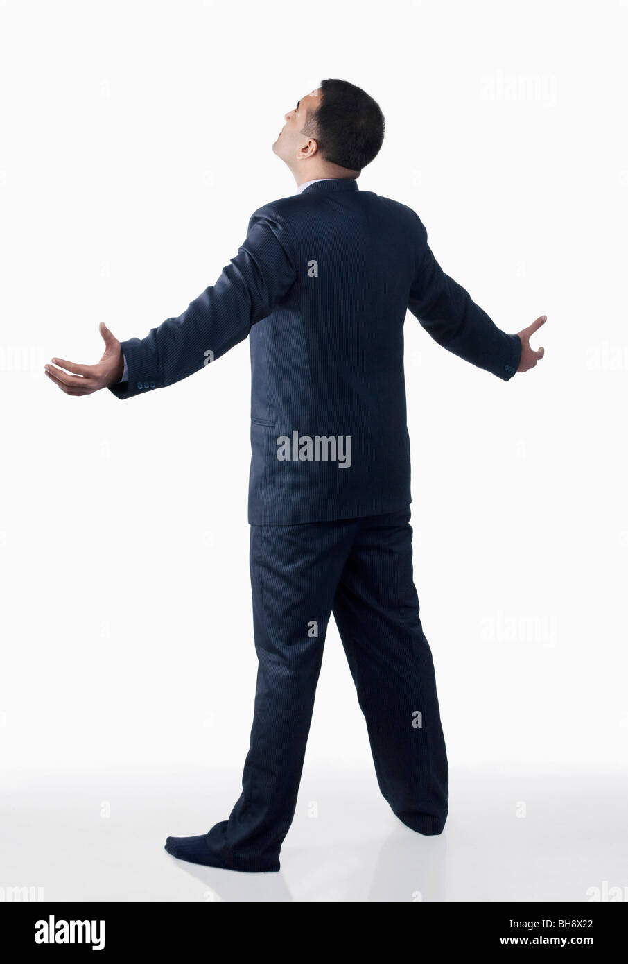 Businessman standing with arms wide open Stock Photo Alamy