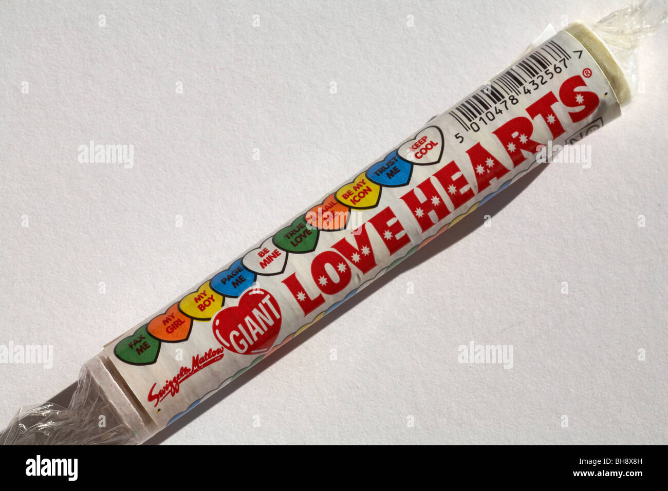 Packet of giant Love heart sweets with messages set on white background