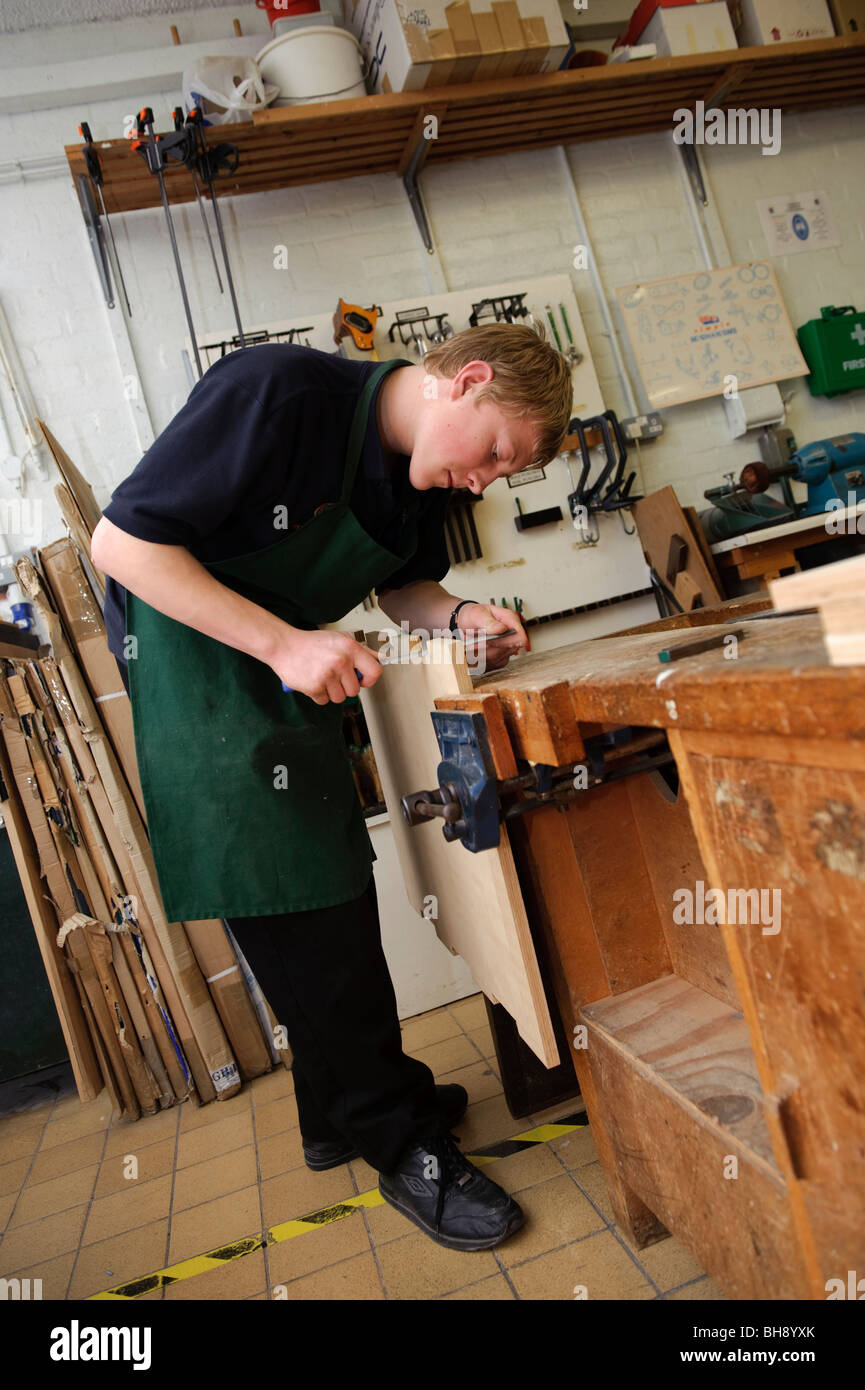 A Teenage boy pupil in DT design technology woodwork workshop class, secondary school, Wales UK Stock Photo