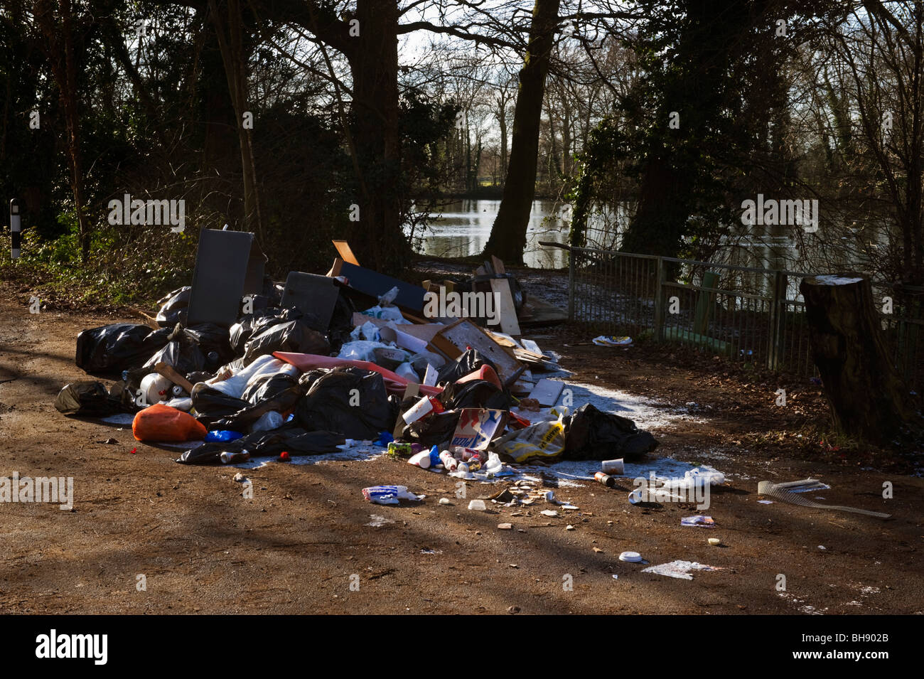 Litter, rubbish and debris, an unsightly mess dumped by the road at Little Britain lake Cowley Middlesex West London UK Stock Photo