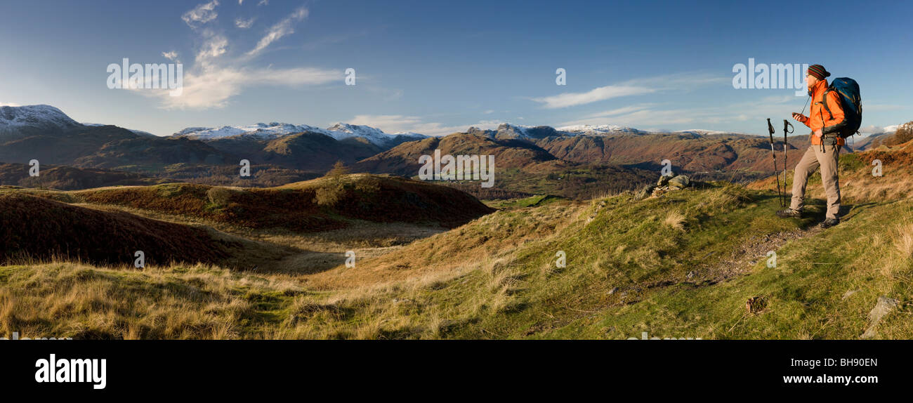 Hiker overlooking Lake District, Cumbria UK Stock Photo