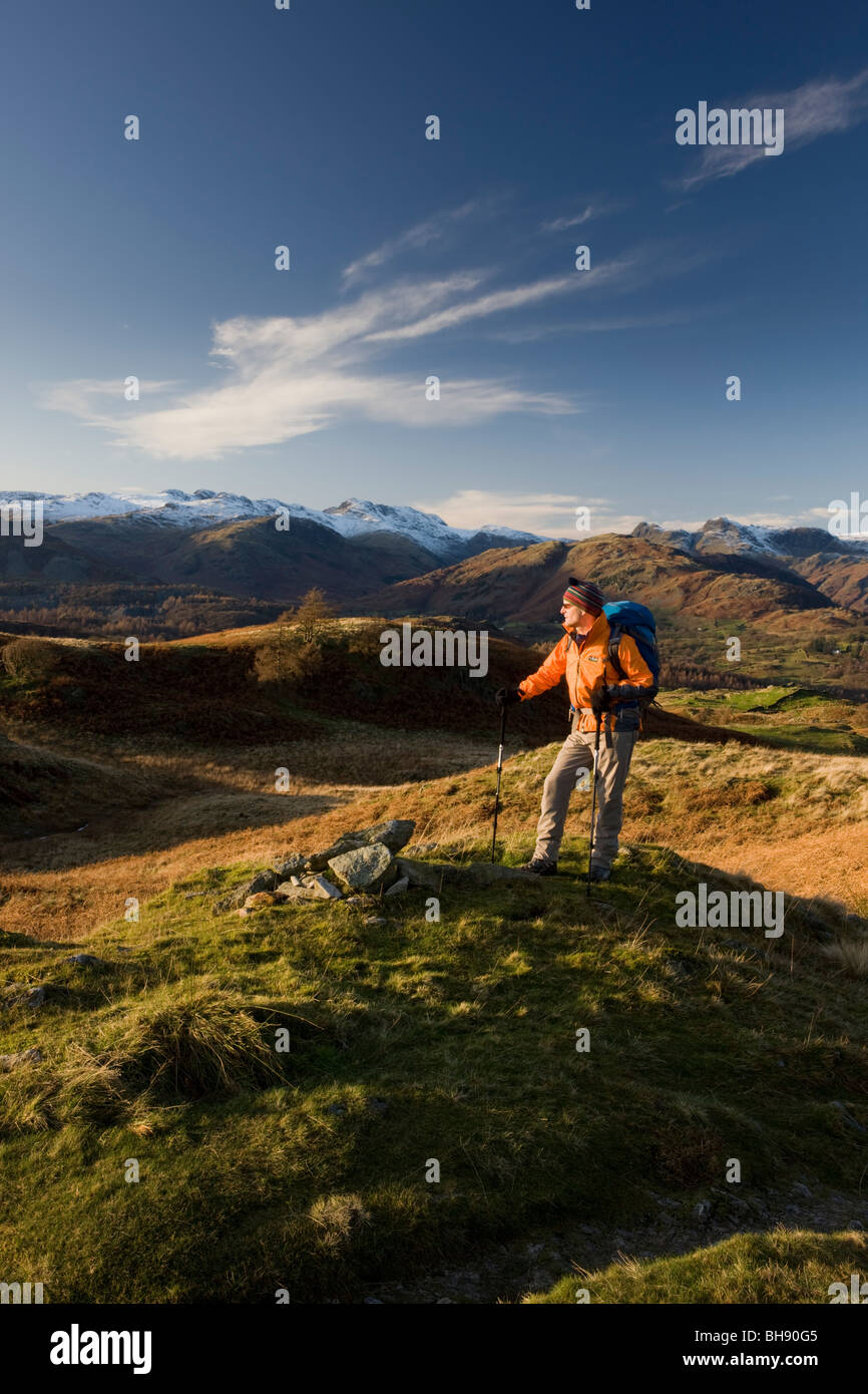 Hiker overlooking Lake District, Cumbria UK Stock Photo
