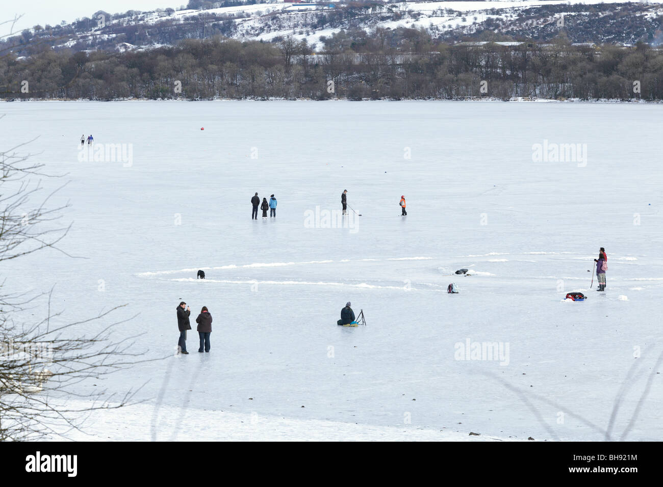 People on frozen Castle Semple Loch in winter, Clyde Muirshiel Regional Park, Lochwinnoch, Renfrewshire, Scotland, UK Stock Photo