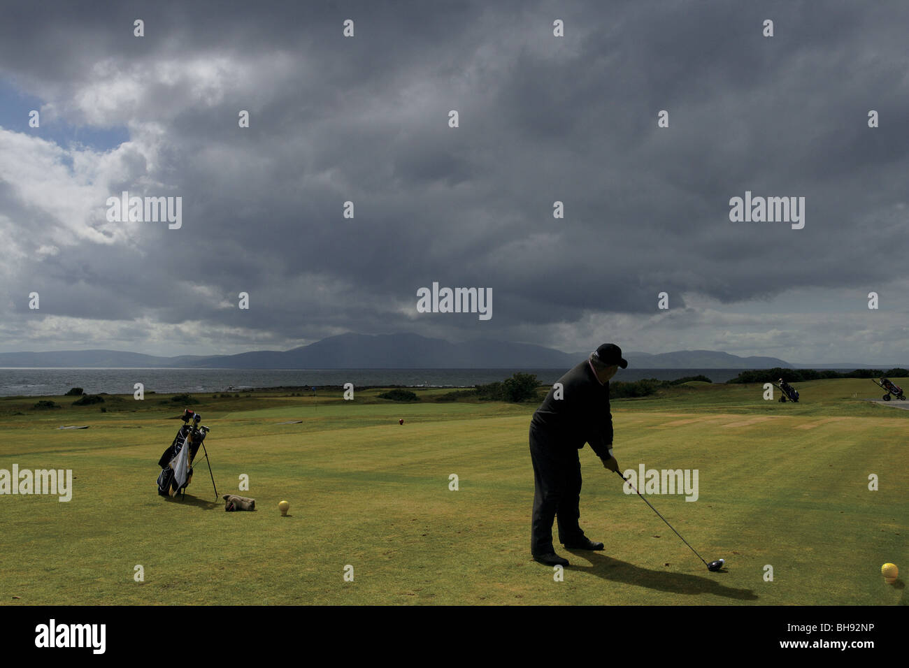 A Golfer Teeing off at West Kilbride Golf Course Ayrshire Scotland Stock Photo