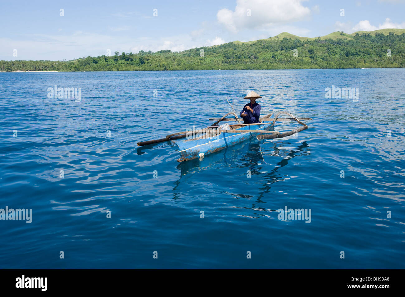 Fisherman on Outrigger Boat, Lembeh Strait, Sulawesi, Indonesia Stock Photo