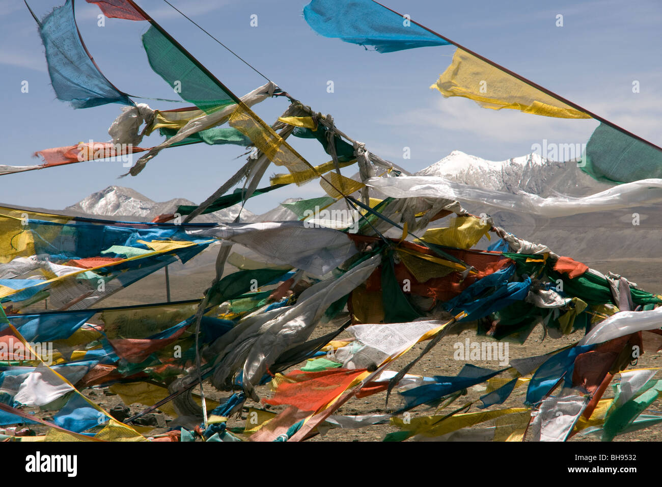 prayer flags and mountain landscape from the summit of the jia tsuo la pass on the friendship highway tibet Stock Photo