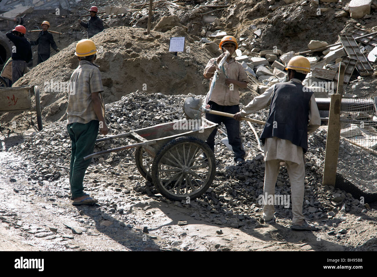 tibetan construction workers repairing the road between nyalam and zhangmu Stock Photo